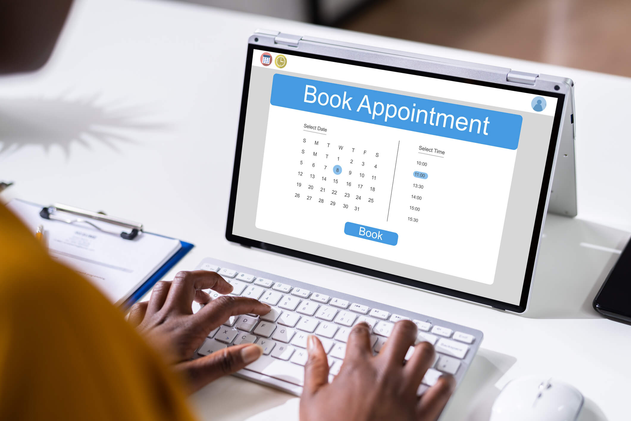 Person booking appointment on laptop