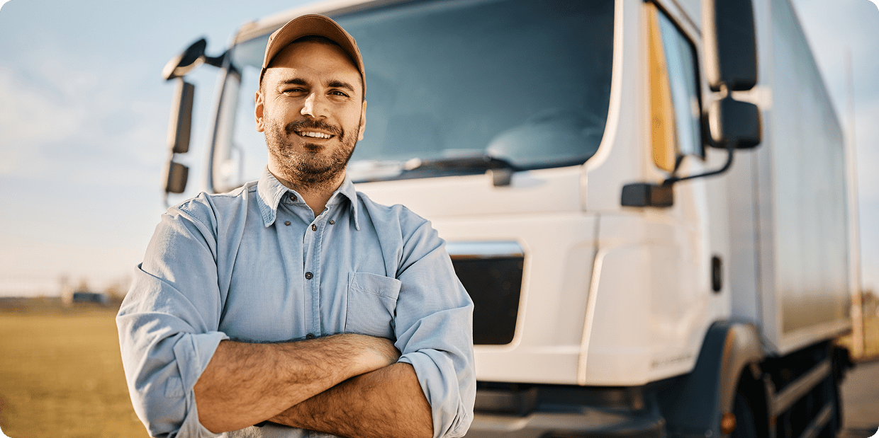 Man standing proudly in front of truck