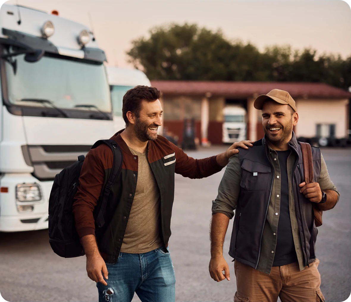 Two men smiling near a truck
