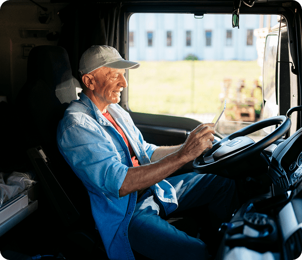 Man in hat driving a truck