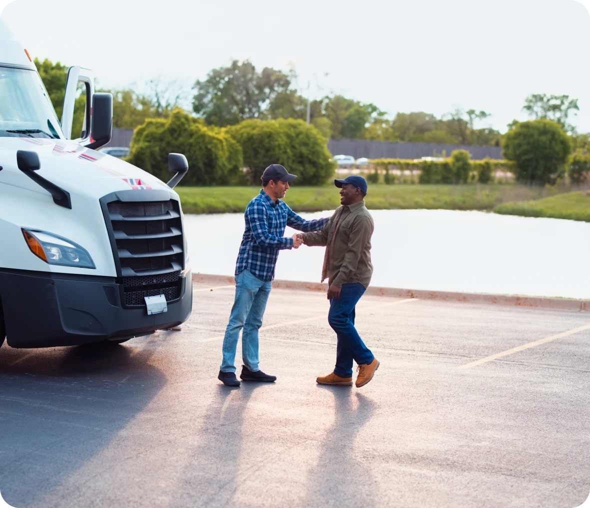 Men greeting near a parked semi-truck.